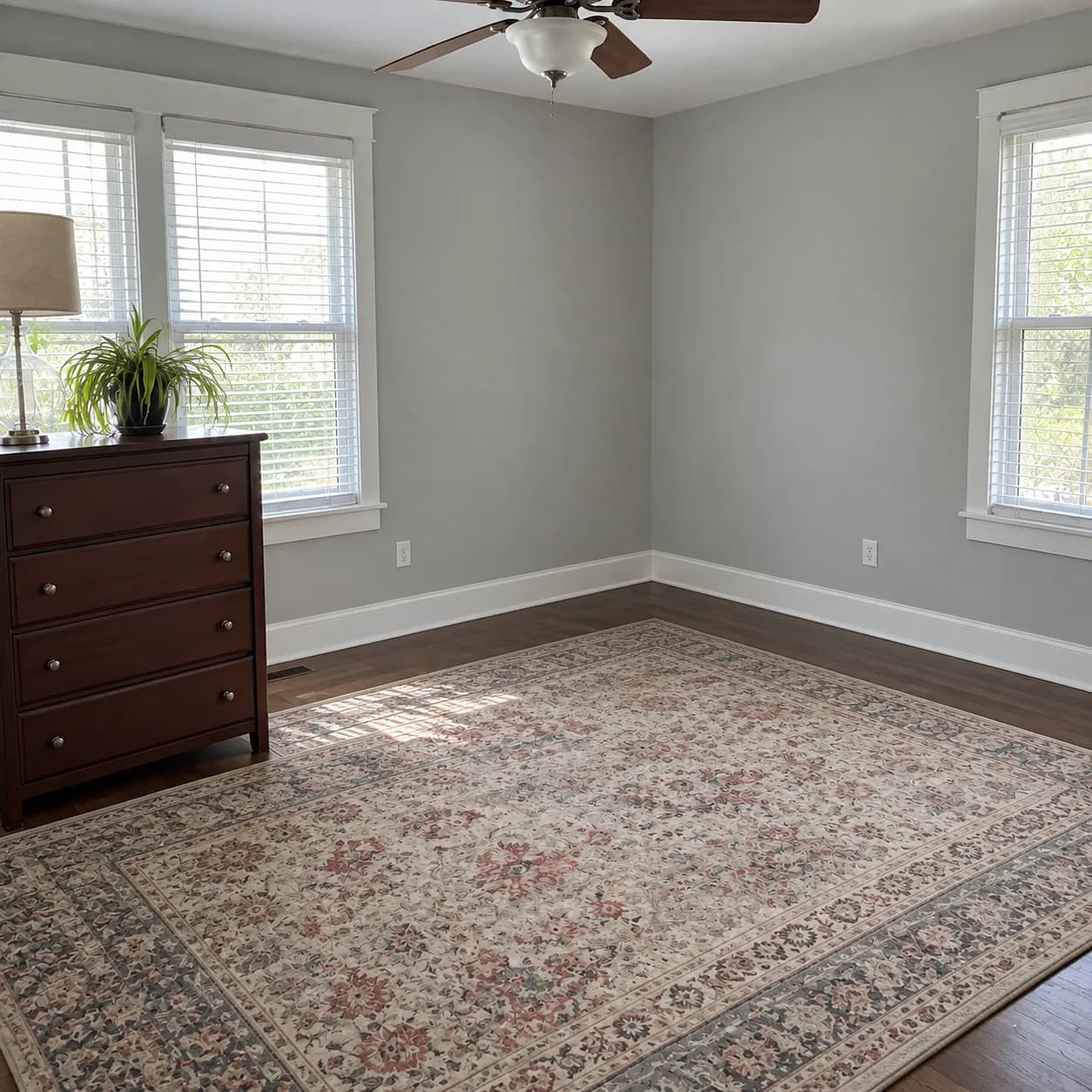 The same bedroom emptied back to the rug and one remaining dresser once the crew had finished